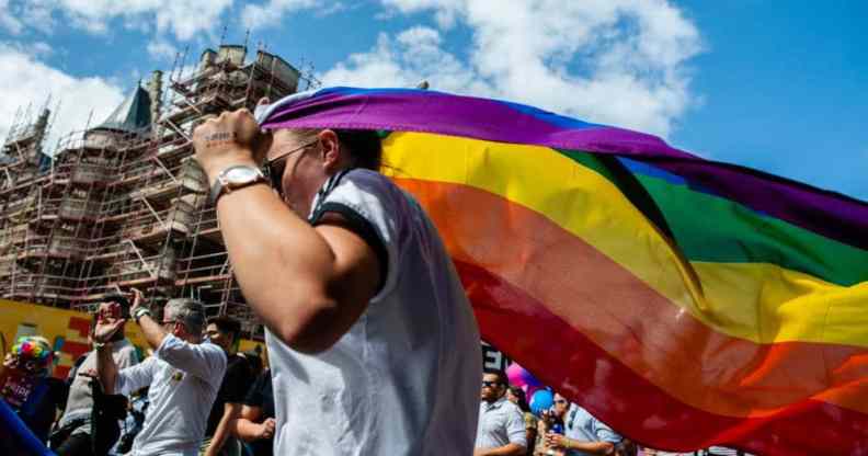 A person holds an LGBT+ Pride flag during the Antwerp Pride event in 2019 the pride march is used to stand up to homophobia and transphobia as well as celebrate the LGBT+ community in Belgium