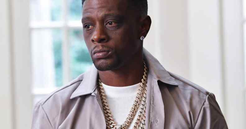 Boosie Badazz in a grey shirt and white t-shirt looking to the right