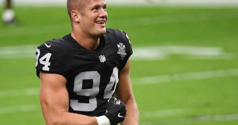 Carl Nassib openly gay NFL player flexes while smiling