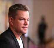 Matt Damon from the side in a white tee and black blazer