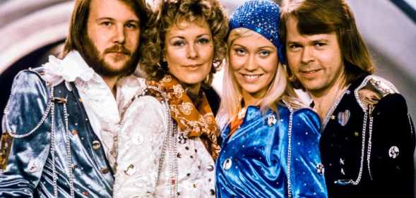 The four original members of ABBA posing for a photo together after winning the Eurovision Song Contest