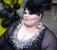 Stacy Layne Matthews poses to the camera in a black dress