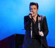 Brandon Flowers of The Killers performs in a black blazer