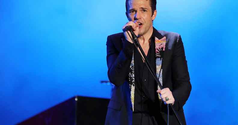 Brandon Flowers of The Killers performs in a black blazer