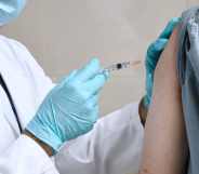 A doctor injects a person with a vaccine