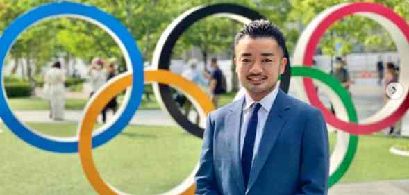 Trans activist and former fencer Fumino Sugiyama smiling in front of olympic rings