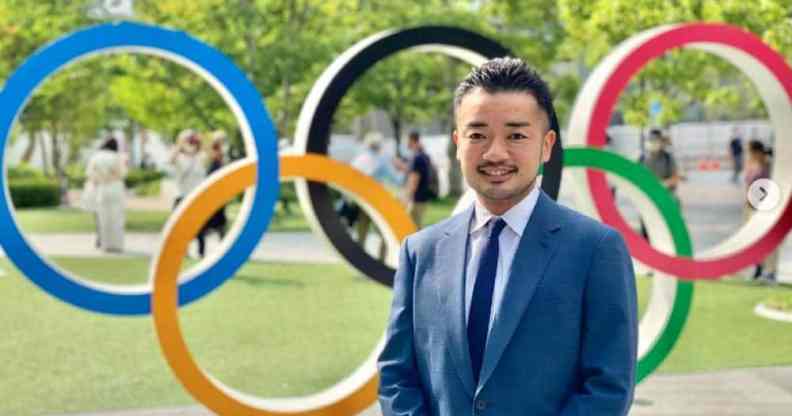 Trans activist and former fencer Fumino Sugiyama smiling in front of olympic rings