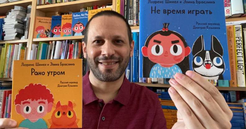 Lawrence Schimel holds Russian translations of children's books 'Early One Morning' and 'Bedtime, Not Playtime!'