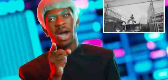 Lil Nas X dressed as a reporter breaking the news that his rapper persona escaped prison in trailer for upcoming debut Montero album