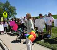 Ivie Hunt, 15, front, and about 50 Valor Christian High School students walked out of classes to support a volleyball coach Inoke Tonga, who says he was forced to leave his job over his sexuality, in front of the high school in Highlands Ranch, Colorado on Tuesday, August 24, 2021.