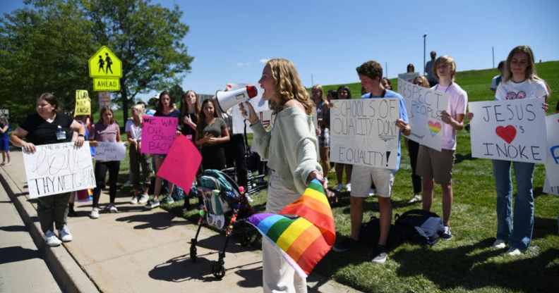 Ivie Hunt, 15, front, and about 50 Valor Christian High School students walked out of classes to support a volleyball coach Inoke Tonga, who says he was forced to leave his job over his sexuality, in front of the high school in Highlands Ranch, Colorado on Tuesday, August 24, 2021.