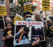 Protestors holding signs reading 'Afghan refugees welcome here' and 'We will be butchered'