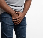 Man holding his hands over his penis