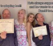 Grace Hyland, Mat Stevenson and Belle Bambi pose around an adoption certificate