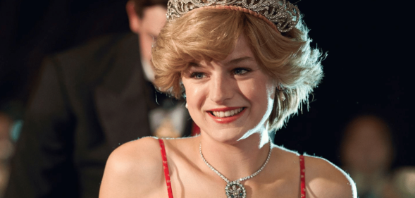 Emma Corrin as PRincess Diana in a red strappy dress, bouffant hair and tiara