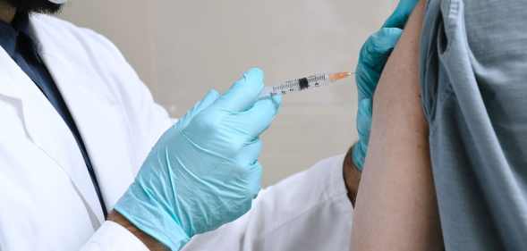 Doctor injects person with a vaccine for HIV