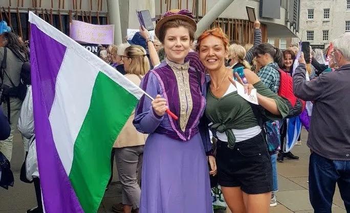 Anti-trans protesters who booed Nicola Sturgeon pose in suffragette colours