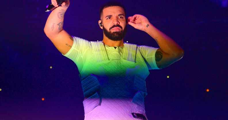Drake with the colours of the rainbow shining on him