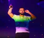 Drake with the colours of the rainbow shining on him