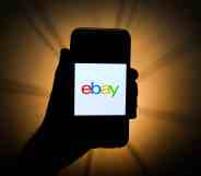 A mobile phone showing the eBay logo