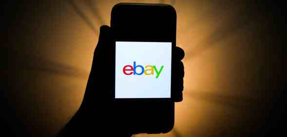 A mobile phone showing the eBay logo