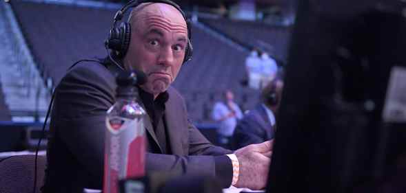 Joe Rogan reacts behind a computer screen