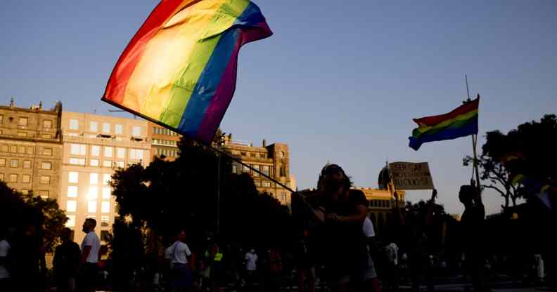 Thousands of people are demonstrating in Barcelona, Spain, waving a rainbow flag