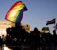 Thousands of people are demonstrating in Barcelona, Spain, waving a rainbow flag