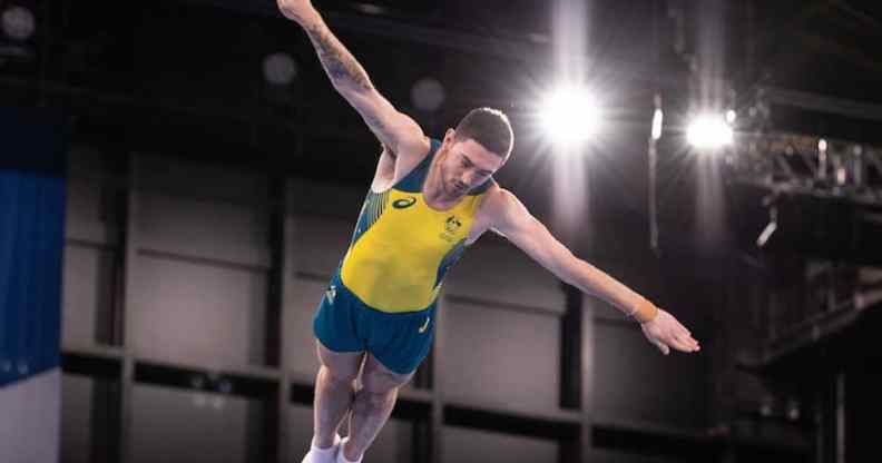 Dominic Clarke jumps with outstretched arms at the Tokyo 2020 Olympics