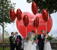 Couples pose during a photo event during a nationwide referendum's day on same-sex marriage, in Swiss capital Bern on September 26, 2021.