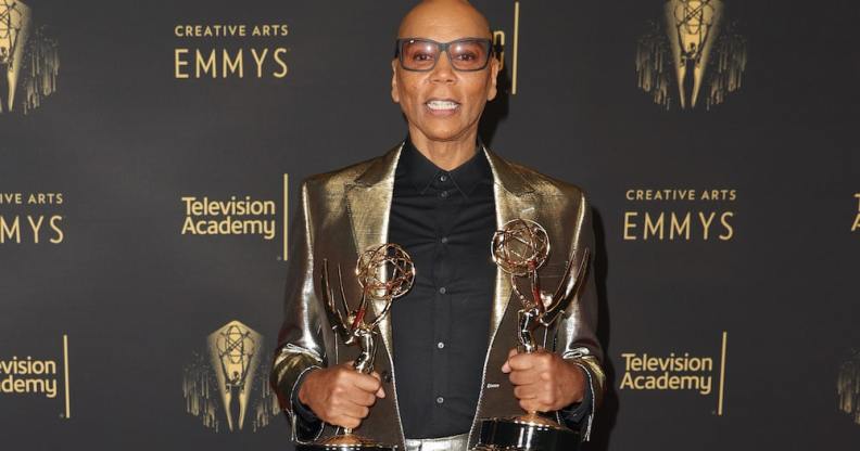 RuPaul on the red carpet at the creative arts Emmys holding his awards