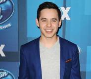 David Archuleta attends FOX's "American Idol" finale for the farewell season at Dolby Theatre in a blue suit jacket and grey shirt