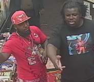 Two men, one wearing red and the other black, stand in a shop