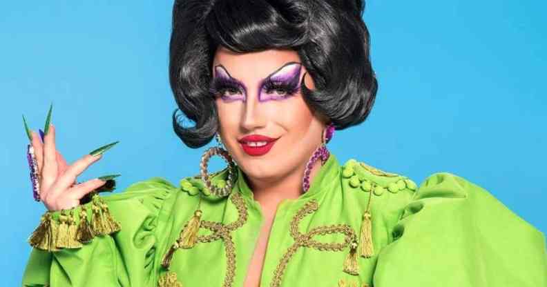 A promotional photo of Drag Race UK series three contestant Choriza May in a green outfit with a beautiful black wig and sharp acrylic nails