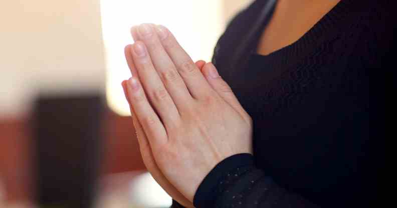 close up of sad woman praying god in church