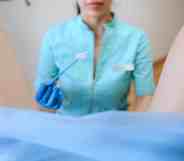nurse performs cervical screening on person with cervix