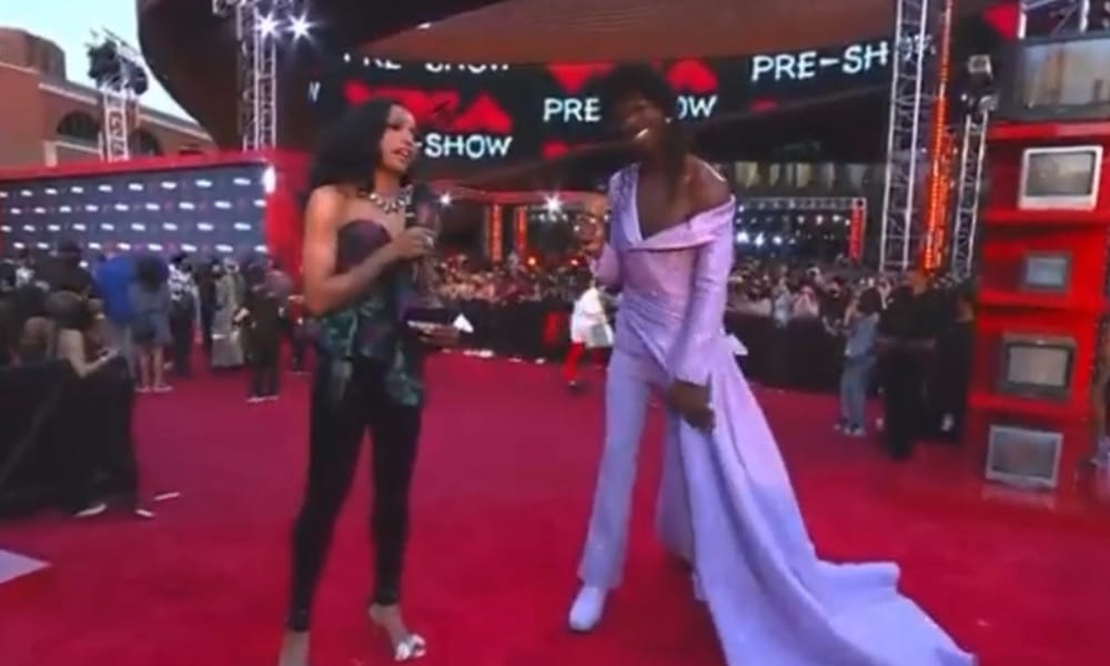 Lil Nas X in a lilac gown and MTV's red carpet host Jamila Mustafa