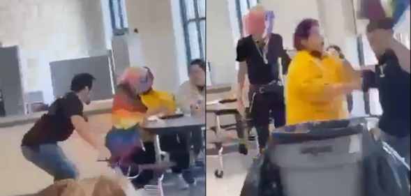A student wrapped in a Pride flag is tugged out of a chair