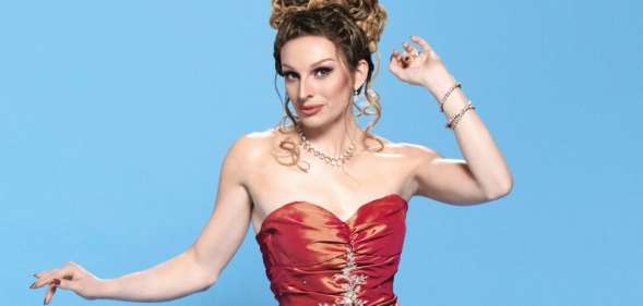 Veronica Green, a drag queen in a red dress with her hair piled on top of her head