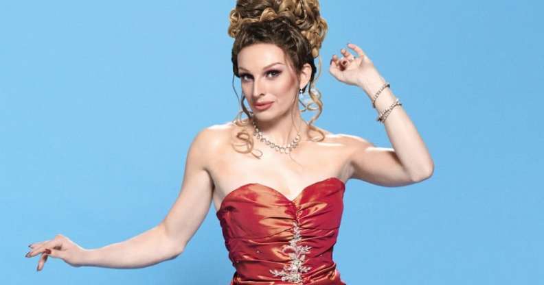 Veronica Green, a drag queen in a red dress with her hair piled on top of her head