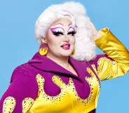 Victoria Scone wearing a purple jumpsuit with yellow, gem-encrusted flames