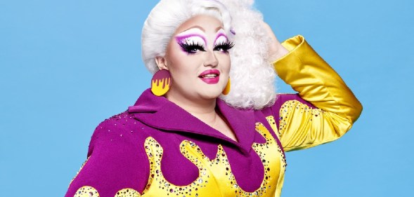 Victoria Scone wearing a purple jumpsuit with yellow, gem-encrusted flames