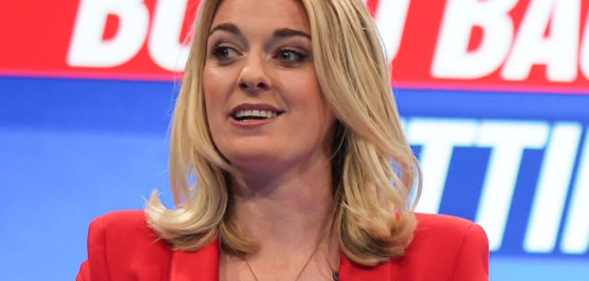 Dehenna Davison MP, wears a 'Tory Scum' badge whilst hosting a Q&A session with Leader of the House of Commons, Jacob Rees Mogg on October 4, 2021 in Manchester, England.