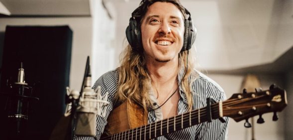 Eric Bolton poses with a guitar