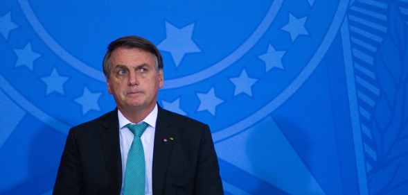 President of Brazil Jair Bolsonaro leans