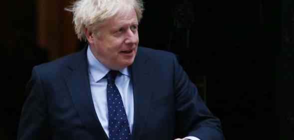 Boris Johnson walks out the door of Number 10