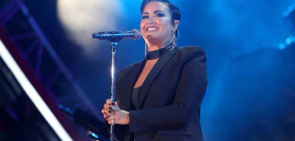 Demi Lovato performs during Global Citizen Live in a black outfit in front of a blue background