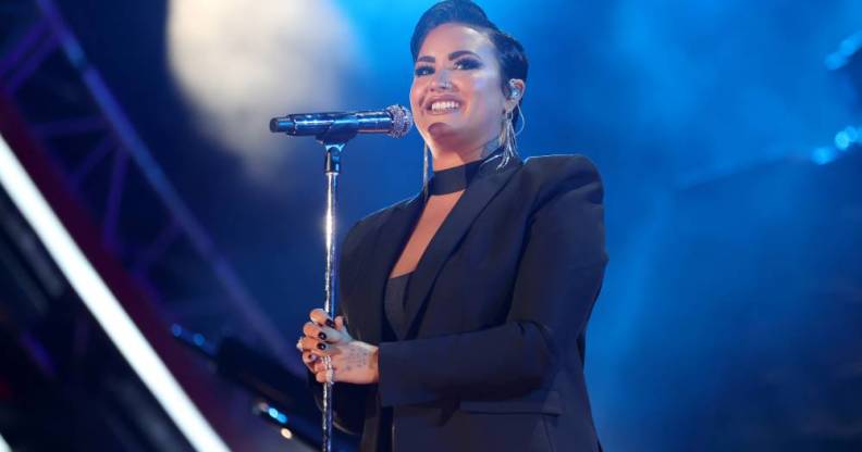 Demi Lovato performs during Global Citizen Live in a black outfit in front of a blue background