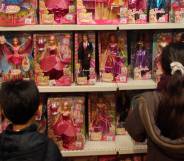 Children look at Barbie dolls in a toy store