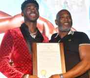 A picture of Lil Nas X and his father Robert Stafford holding up a plaque at a homecoming event for the rapper in Atlanta Georgia